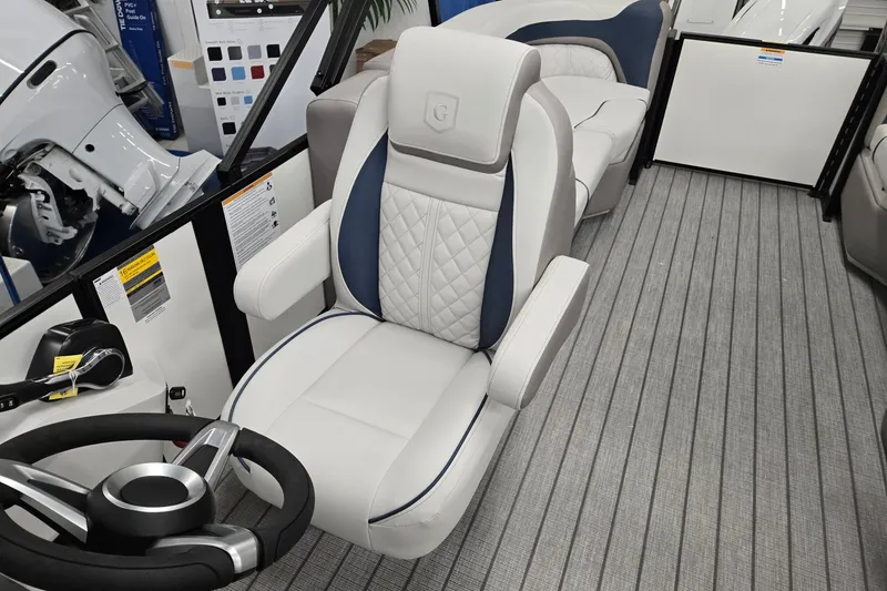 Slide: The Image of 2027 Godfrey Sweetwater 2286 SBC boat interior with luxurious captain's chair and steering wheel. - 9