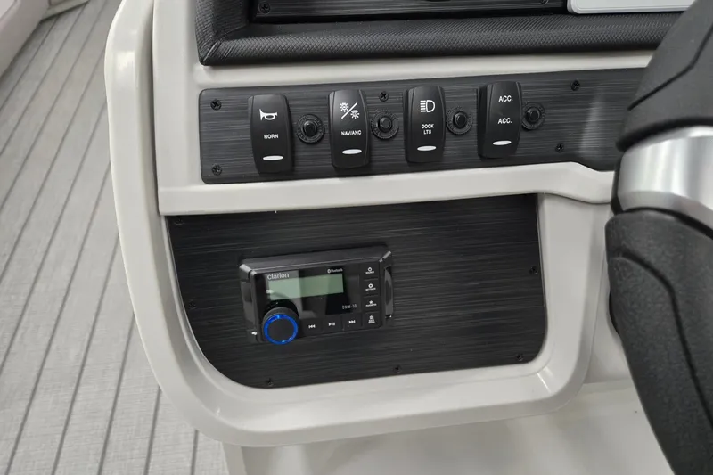 Slide: The Image of Control panel of 2027 Godfrey Sweetwater 2286 SBC boat with switches and audio system. - 12