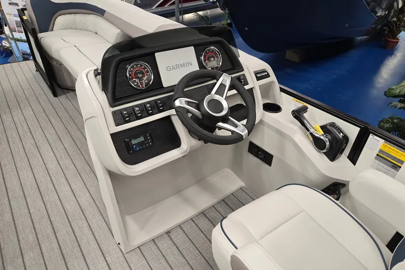 Slide: The Image of 2027 Godfrey Sweetwater 2286 SBC boat interior with Garmin dashboard and steering wheel. - 27