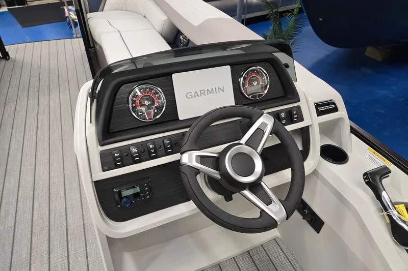Slide: The Image of 2027 Godfrey Sweetwater 2286 SBC boat dashboard with Garmin display and steering wheel. - 10