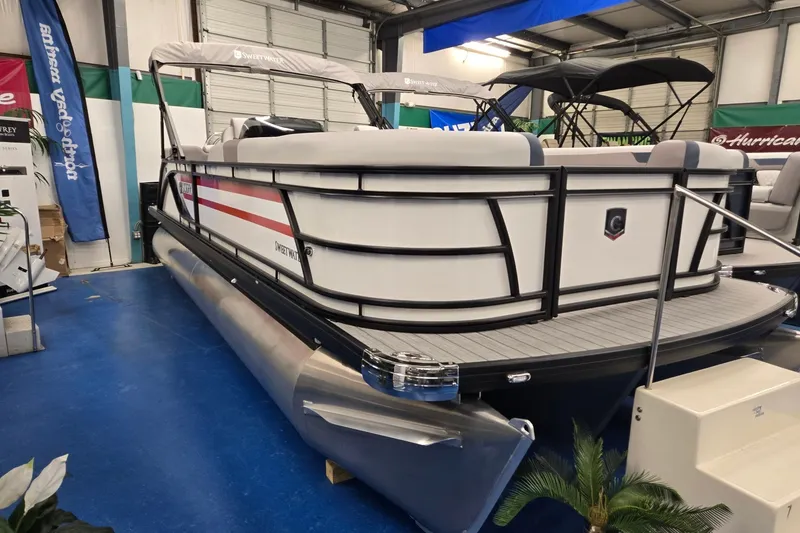 Slide: The Image of 2027 Godfrey Sweetwater 2286 SBC pontoon boat displayed indoors. - 1