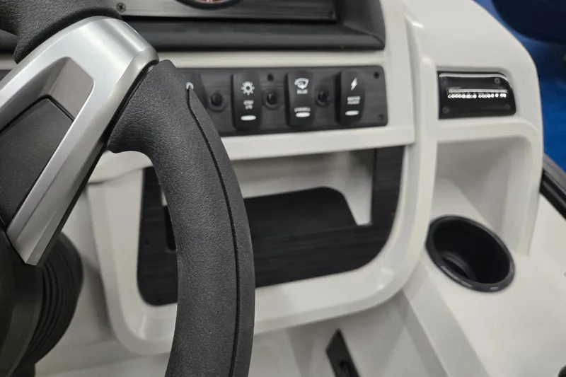 Slide: The Image of Steering wheel and control panel of 2027 Godfrey Sweetwater 2286 SBC boat. - 13