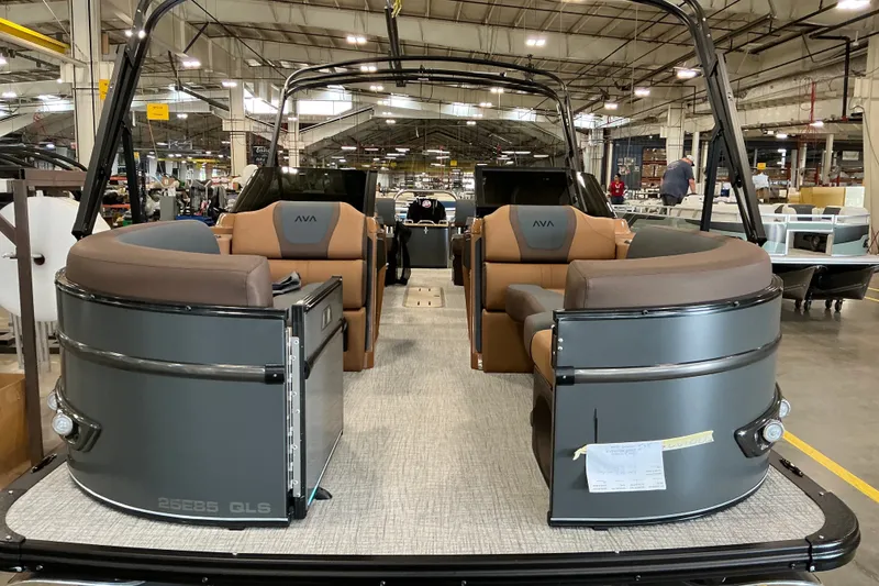 Slide: The Image of 2027 Avalon Catalina Platinum Quad Lounge boat interior in a manufacturing facility. - 2