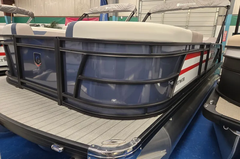 Slide: The Image of 2027 Godfrey Sweetwater 2286 SFLC pontoon boat in showroom, featuring sleek design and modern amenities. - 2