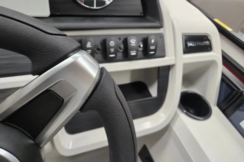 Slide: The Image of Steering wheel and control panel of 2027 Godfrey Sweetwater 2286 SFLC boat. - 12