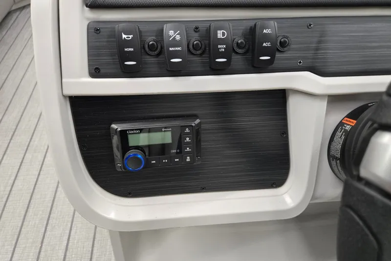 Slide: The Image of Control panel of 2027 Godfrey Sweetwater 2286 SFLC boat with switches and Clarion audio system. - 11