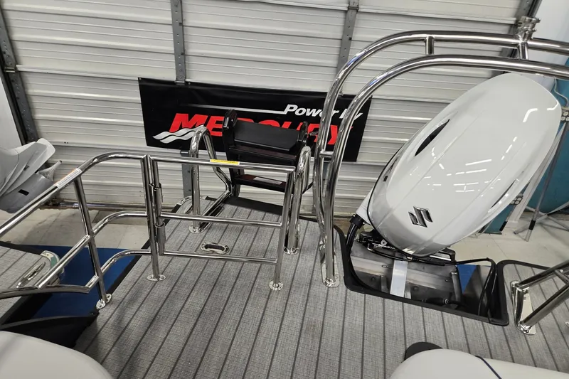 Slide: The Image of 2027 Godfrey Sweetwater 2286 SFLC boat with Suzuki outboard motor in a showroom. - 16
