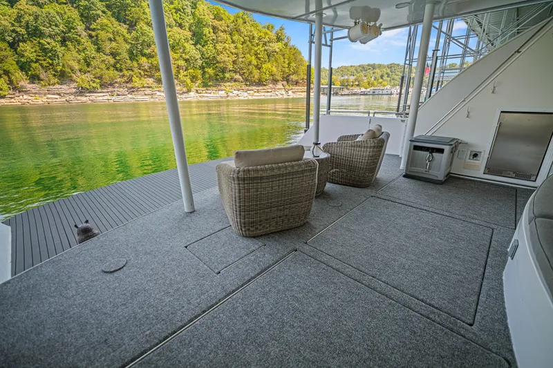 Slide: The Image of Luxurious 2010 Stardust Cruisers houseboat deck with wicker chairs, scenic lake view. - 22