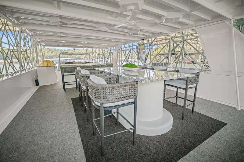 Slide: The Image of Spacious upper deck of 2010 Stardust Cruisers houseboat with modern seating and scenic views. - 17