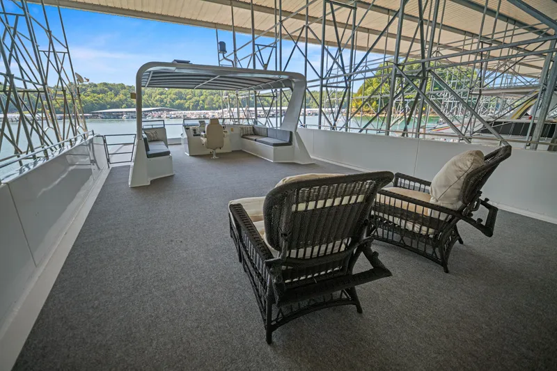Slide: The Image of Spacious upper deck of 2010 Stardust Cruisers houseboat with wicker chairs and scenic lake view. - 18