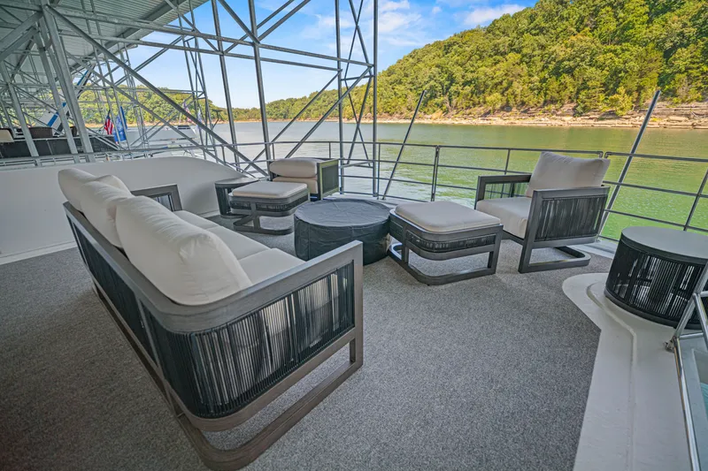 Slide: The Image of Luxurious outdoor seating on 2010 Stardust Cruisers houseboat, overlooking serene lake and lush greenery. - 20