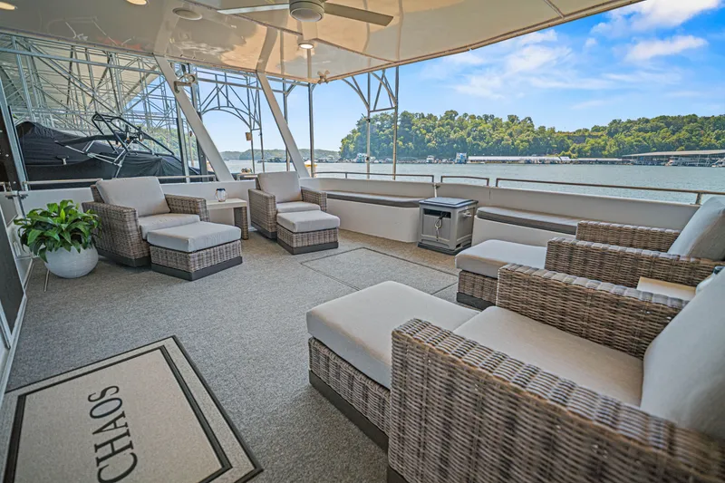 Slide: The Image of Luxurious 2010 Stardust Cruisers houseboat deck with wicker seating, scenic waterfront view. - 23