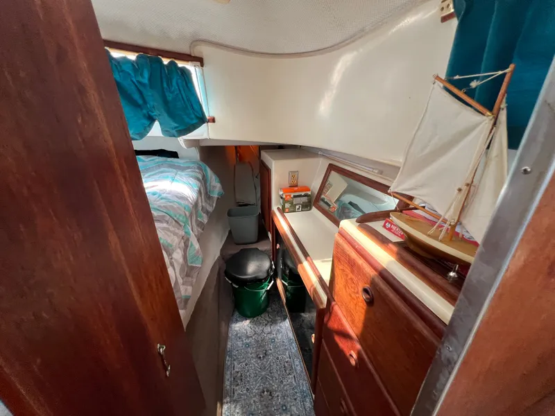 Slide: The Image of Interior of a 1993 Gemini Catamaran 3400 with bed, cabinet, and model boat. - 8