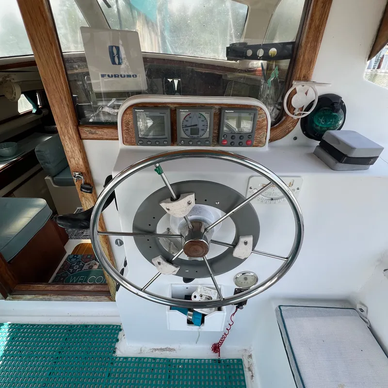 Slide: The Image of The image shows the helm of a 1993 Gemini Catamaran 3400 with instruments and controls. - 4