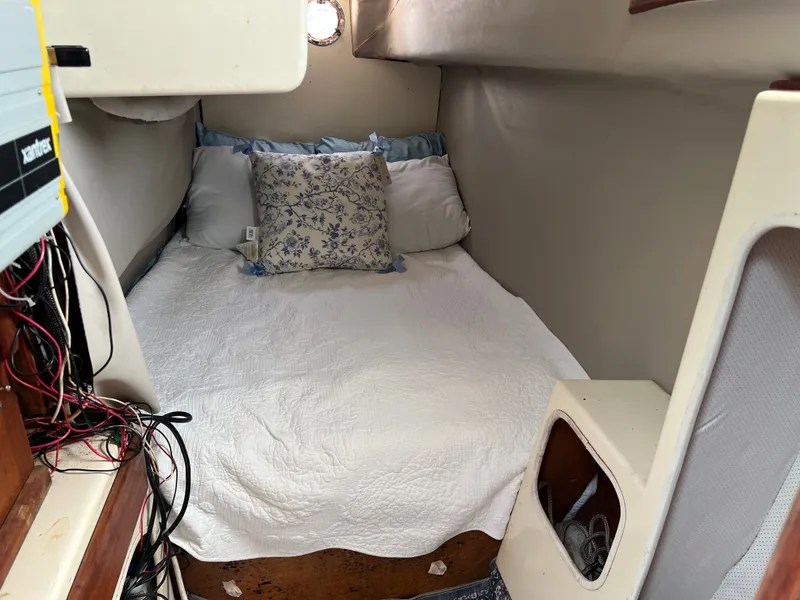 Slide: The Image of The image shows a cozy cabin with a double bed, surrounded by soft pillows and blankets. - 10