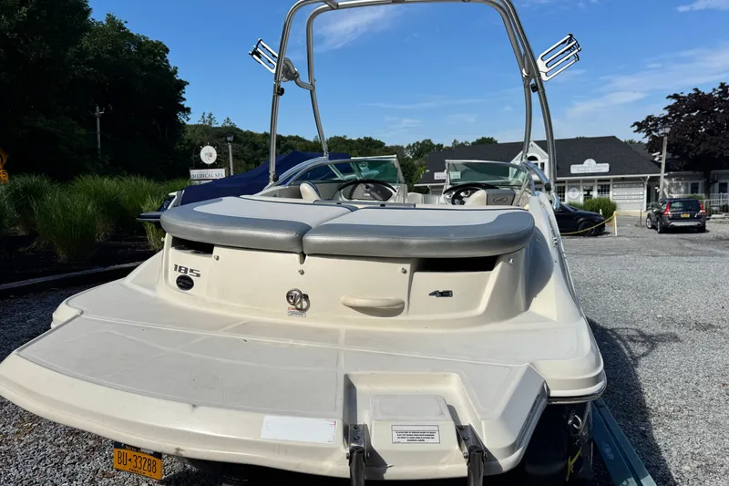 Slide: The Image of 2010 Sea Ray 185 Sport boat parked outdoors on a sunny day. - 1