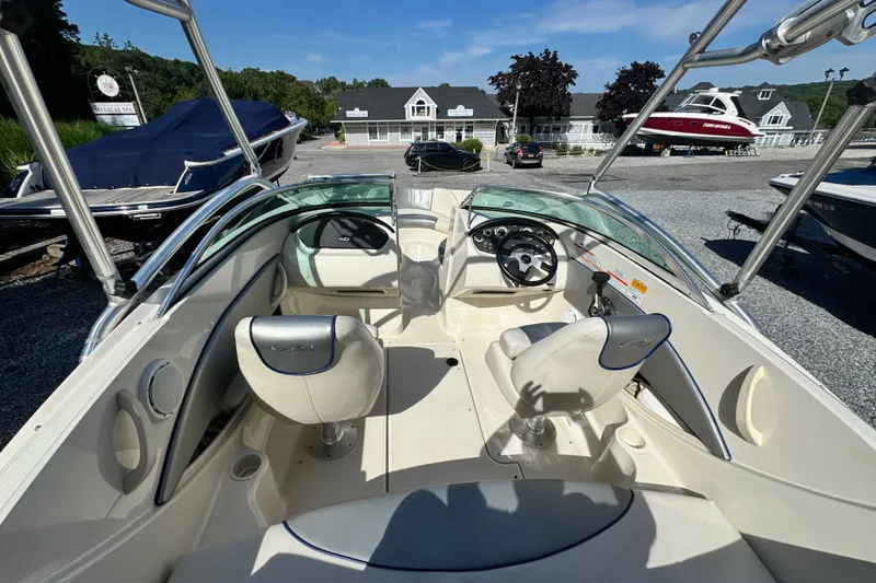 Slide: The Image of Interior view of a 2010 Sea Ray 185 Sport boat with steering wheel and seating. - 8
