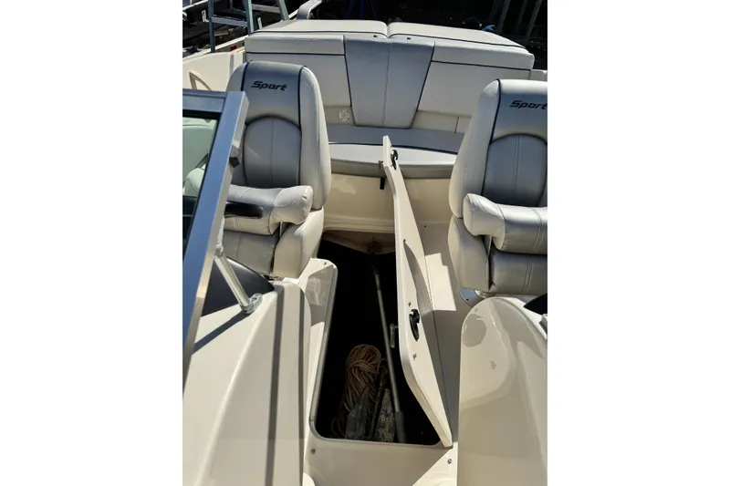 Slide: The Image of 2010 Sea Ray 185 Sport boat interior with open storage compartment and seating. - 9