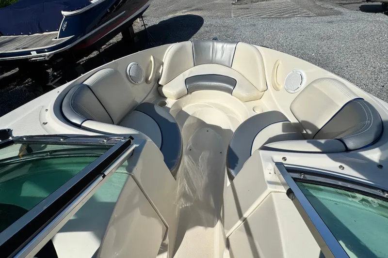 Slide: The Image of 2010 Sea Ray 185 Sport boat interior with cushioned seating and speakers. - 5