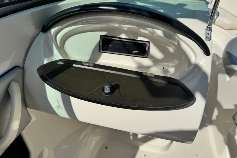 Slide: The Image of Dashboard compartment of a 2010 Sea Ray 185 Sport boat, open with USB port visible. - 10