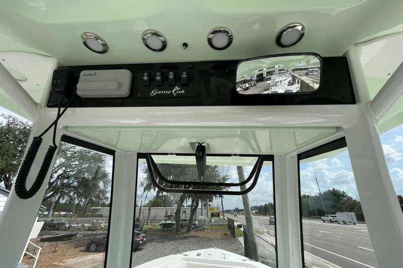 Slide: The Image of 2021 Sea Hunt Gamefish 25 boat console with Garmin electronics and rearview mirror. - 13