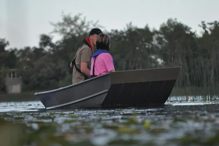 Slide: The Image of Manufacturer Provided Image: Couple in a 2022 Lund 1240 boat on a serene lake. - 4