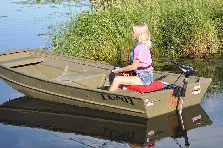 Slide: The Image of Manufacturer Provided Image: 2022 Lund 1240 boat on a lake with a person steering. - 3