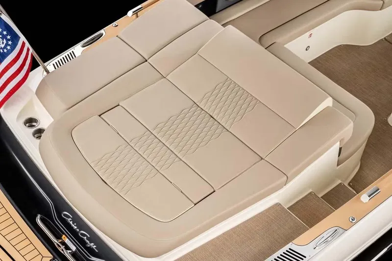 Slide: The Image of Manufacturer Provided Image: Manufacturer Provided Image: 2025 Chris-Craft Sportster 28 boat with beige seating and American flag. - 8