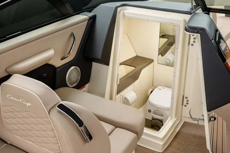 Slide: The Image of Manufacturer Provided Image: Manufacturer Provided Image: 2025 Chris-Craft Sportster 28 interior with luxurious seating and compact bathroom. - 6