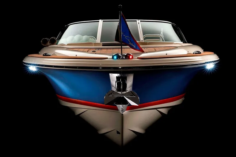 Slide: The Image of Manufacturer Provided Image: 2025 Chris-Craft Launch 27 boat, front view, sleek design, illuminated against black background. - 14