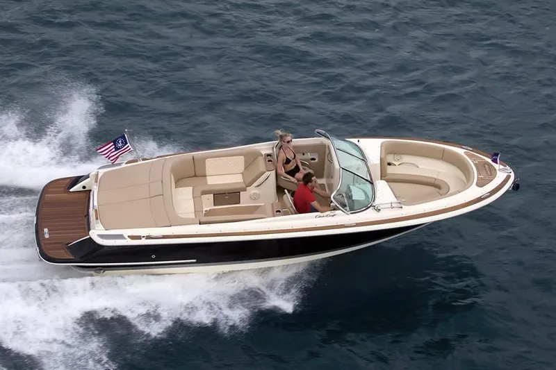Slide: The Image of Manufacturer Provided Image: 2025 Chris-Craft Launch 27 cruising on open water, showcasing sleek design and luxury features. - 1