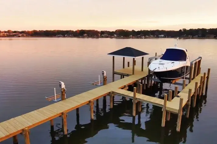 Slide: The Image of 2010 Sea Ray Sundancer 330 docked on a serene lake at sunset. - 1