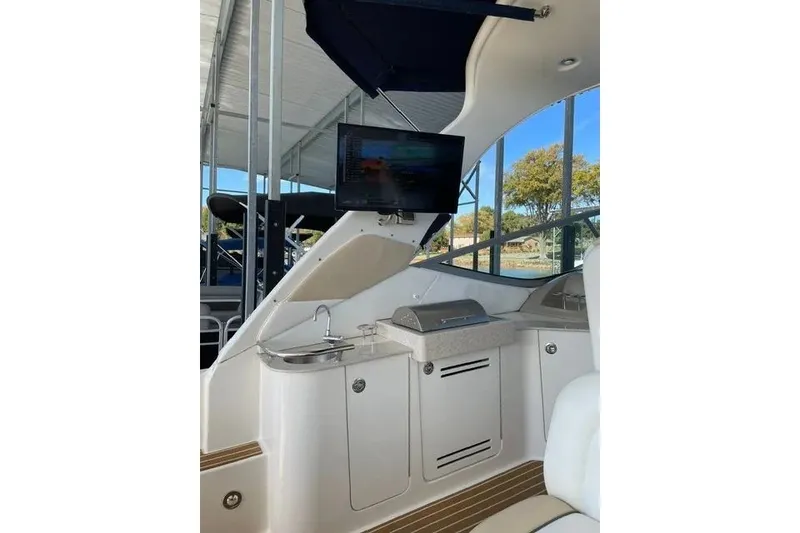 Slide: The Image of Interior of 2010 Sea Ray Sundancer 330 with kitchenette and mounted TV. - 10