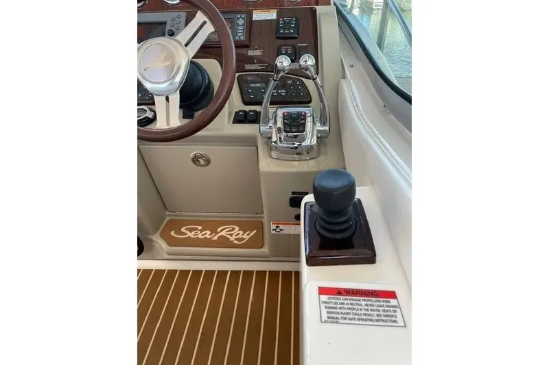 Slide: The Image of Cockpit of 2010 Sea Ray Sundancer 330 with steering wheel and controls. - 9