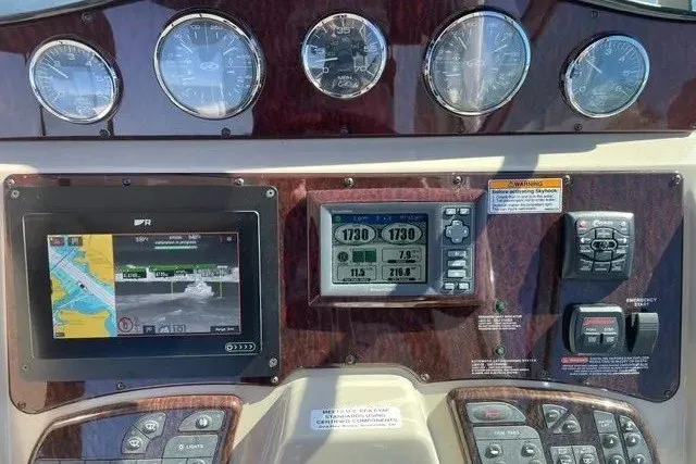 Slide: The Image of Dashboard of a 2010 Sea Ray Sundancer 330 with navigation and control instruments. - 12