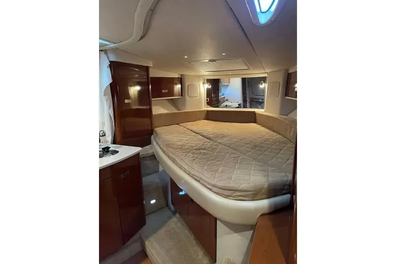 Slide: The Image of Interior cabin of 2010 Sea Ray Sundancer 330 with cozy bed and wooden cabinetry. - 15