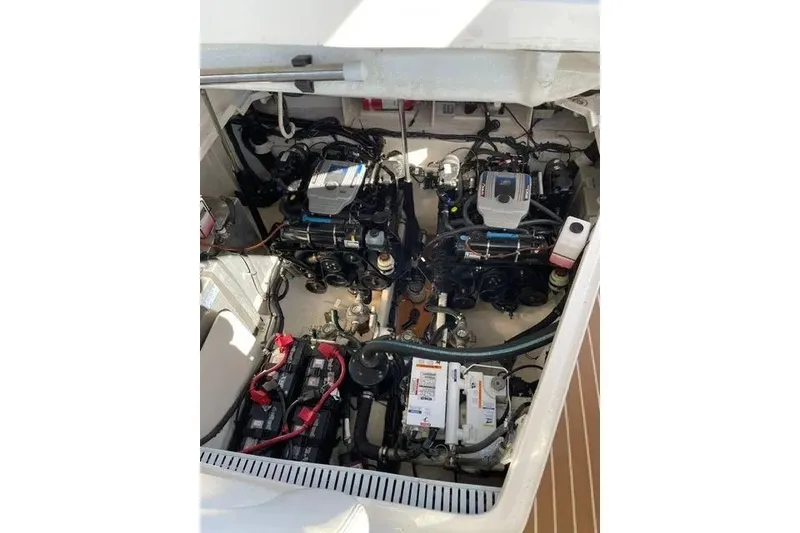 Slide: The Image of Engine compartment of a 2010 Sea Ray Sundancer 330, showcasing dual engines and mechanical components. - 19