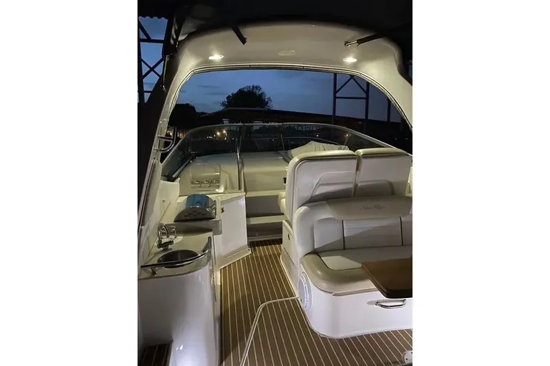 Slide: The Image of 2010 Sea Ray Sundancer 330 interior with seating and lighting at dusk. - 3