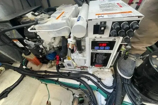 Slide: The Image of Engine compartment of a 2010 Sea Ray Sundancer 330, showcasing mechanical components and wiring. - 20