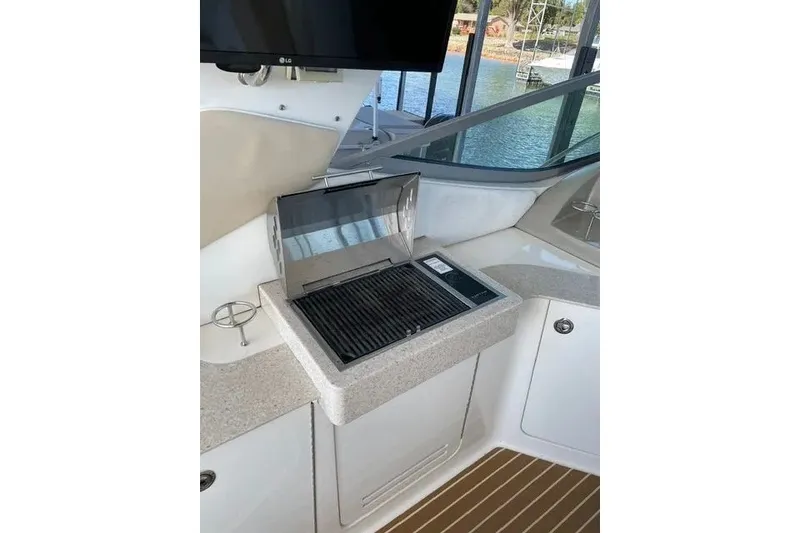Slide: The Image of Outdoor grill on 2010 Sea Ray Sundancer 330 yacht, featuring sleek countertop and scenic view. - 7