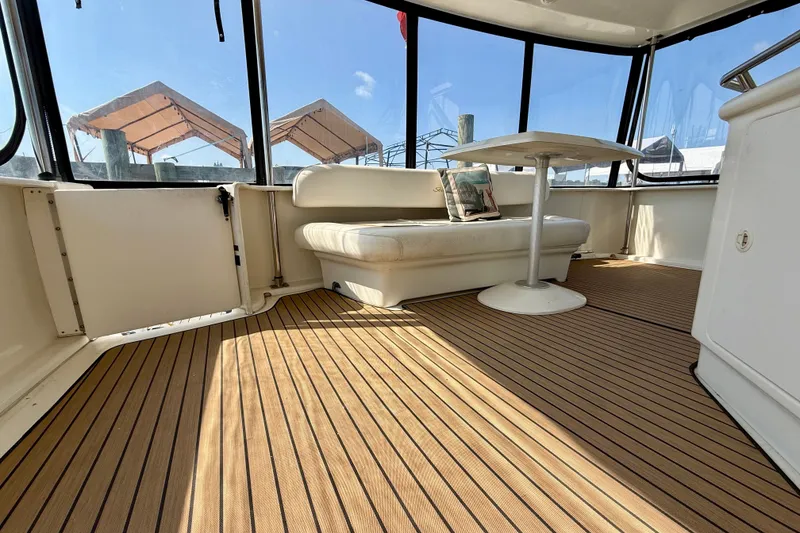 Slide: The Image of Spacious interior of 2000 Sea Ray 380 Aft Cabin with seating and table. - 3
