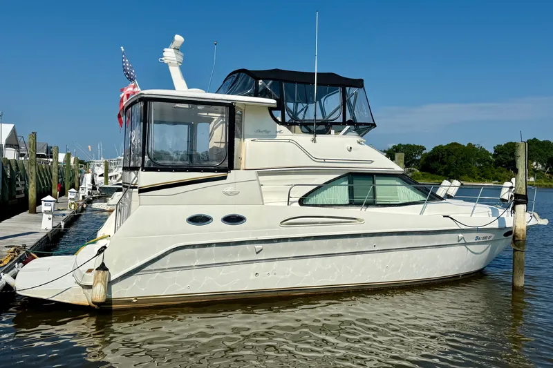 Slide: The Image of 2000 Sea Ray 380 Aft Cabin yacht docked at marina under clear blue sky. - 1