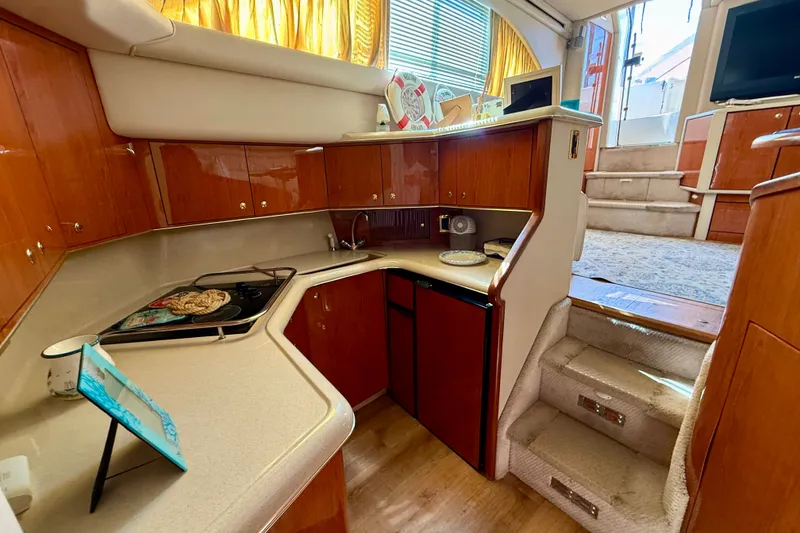 Slide: The Image of Luxurious 2000 Sea Ray 380 Aft Cabin yacht interior with modern kitchen and cozy stairs. - 32