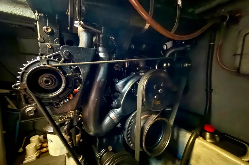 Slide: The Image of Engine compartment of a 2000 Sea Ray 380 Aft Cabin boat, showcasing mechanical components. - 16