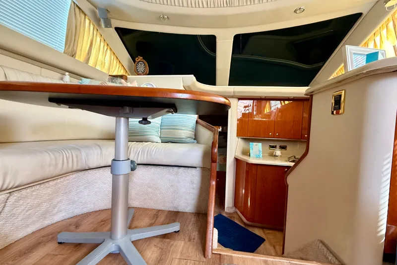 Slide: The Image of Interior of 2000 Sea Ray 380 Aft Cabin yacht with elegant seating and wooden cabinetry. - 12