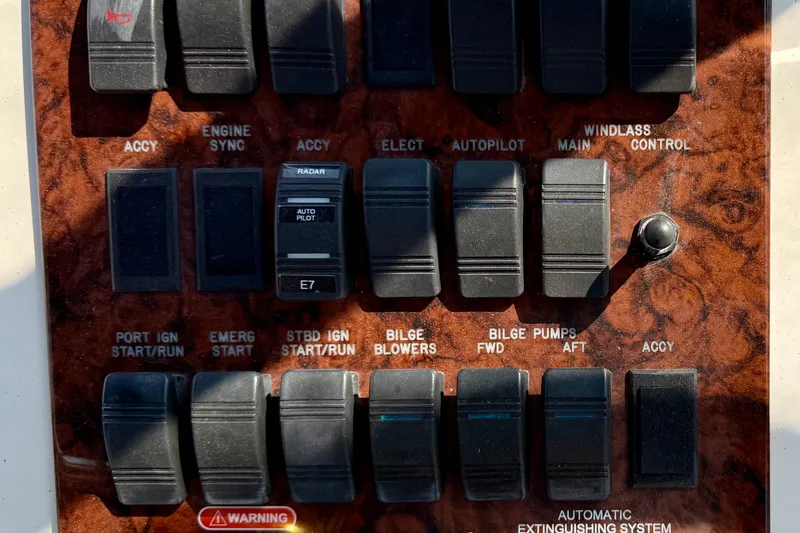 Slide: The Image of Control panel of a 2000 Sea Ray 380 Aft Cabin boat with various switches. - 27