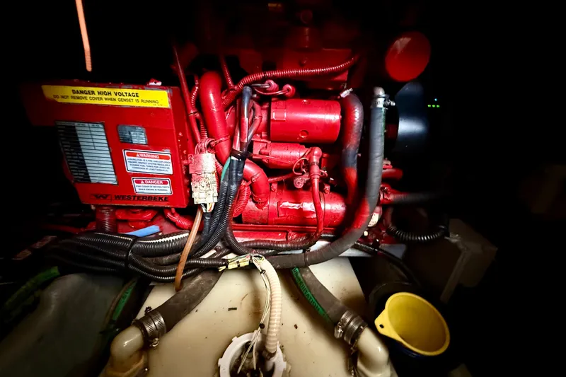 Slide: The Image of Engine compartment of a 2000 Sea Ray 380 Aft Cabin with visible wiring and components. - 15