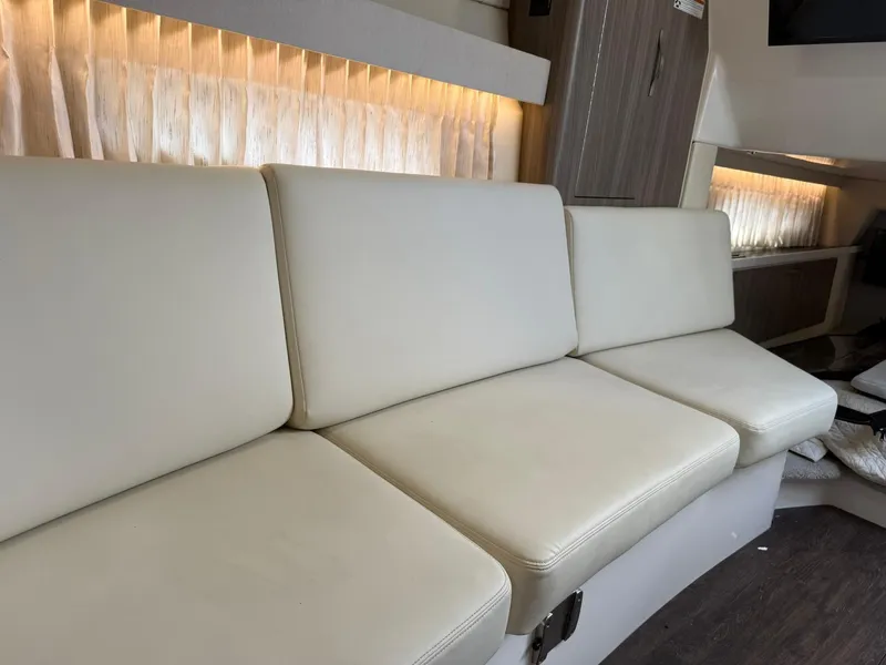 Slide: The Image of Luxurious interior seating of 2021 Regal 33 XO boat with elegant lighting. - 17