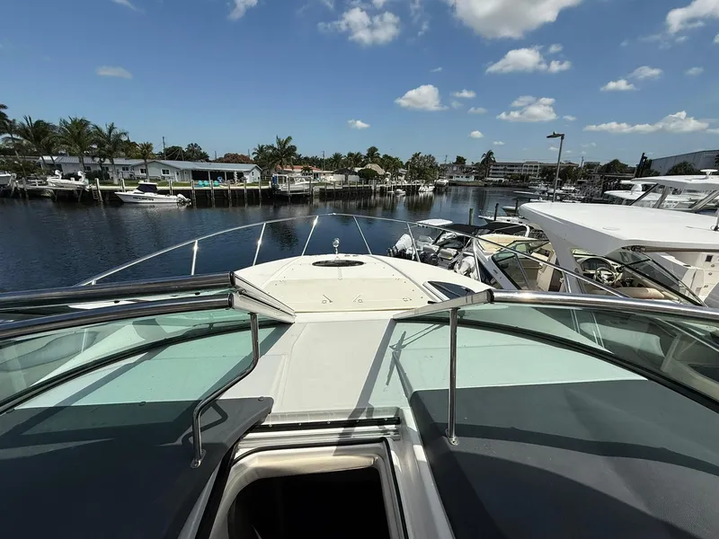 Slide: The Image of 2021 Regal 33 XO yacht docked in a sunny marina with clear skies. - 13