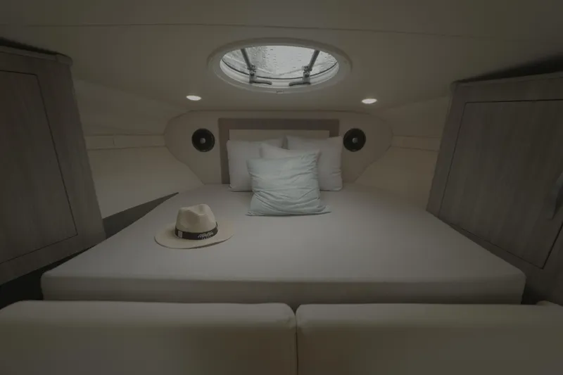 Slide: The Image of Cozy cabin interior of 2021 Regal 33 XO yacht with bed and hat. - 24